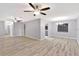Bright, open living space with ceiling fans, recessed lighting, and neutral-toned flooring at 15609 Timberline Dr, Tampa, FL 33624