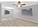 Spacious living room with modern ceiling fan and beautiful wood-look laminate flooring at 15609 Timberline Dr, Tampa, FL 33624