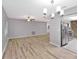 Bright living room features modern light fixture and attractive wood-look laminate flooring at 15609 Timberline Dr, Tampa, FL 33624