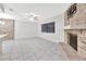 Spacious living room featuring tile flooring, a ceiling fan, and a decorative brick fireplace at 15609 Timberline Dr, Tampa, FL 33624