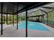 Screened in pool area with pool and patio area for entertaining at 15609 Timberline Dr, Tampa, FL 33624