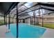 Backyard pool featuring screened-in area with pool at 15609 Timberline Dr, Tampa, FL 33624