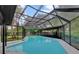 Outdoor pool with a screen, providing protection from bugs and debris at 15609 Timberline Dr, Tampa, FL 33624