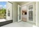 View of a screened back porch from the interior featuring an open doorway and light-filled home interior at 11314 Grand Park Ave, Riverview, FL 33578