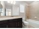 Full bathroom featuring a tub-shower combination and dark-stained vanity at 11314 Grand Park Ave, Riverview, FL 33578