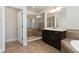 Modern bathroom featuring a glass shower and vanity with dark wood cabinets at 11314 Grand Park Ave, Riverview, FL 33578