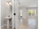 Elegant bathroom with a pedestal sink and view into the living area at 11314 Grand Park Ave, Riverview, FL 33578