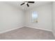 Cozy bedroom featuring neutral colors, a ceiling fan and a large window at 11314 Grand Park Ave, Riverview, FL 33578