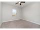 Clean, carpeted bedroom featuring a ceiling fan and natural light at 11314 Grand Park Ave, Riverview, FL 33578