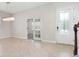 Inviting entryway featuring a decorative chandelier, glass french doors, and stairwell with wooden banister at 11314 Grand Park Ave, Riverview, FL 33578