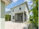 Back exterior view of the home showing the screened porch and paver patio at 11314 Grand Park Ave, Riverview, FL 33578