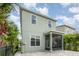 Two-story home with a screened-in porch and paver patio surrounded by tropical landscaping at 11314 Grand Park Ave, Riverview, FL 33578