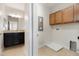 Well-lit laundry room area with cabinetry, tile flooring, and washer/dryer hookups in a home setting at 11314 Grand Park Ave, Riverview, FL 33578