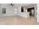 Open-concept living space featuring tile floors, modern ceiling fan, and seamless access to kitchen area at 11314 Grand Park Ave, Riverview, FL 33578