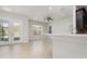 Bright living area featuring neutral tile, direct access to the backyard through elegant glass doors at 11314 Grand Park Ave, Riverview, FL 33578