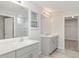 Bathroom featuring double sinks, light gray cabinets, quartz countertop, and large mirrors at 12829 Scarlet Star Dr, Riverview, FL 33579