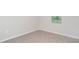Cozy bedroom with gray carpet, a window and white trim at 12829 Scarlet Star Dr, Riverview, FL 33579