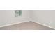 Clean and simple bedroom with neutral carpet and a window at 12829 Scarlet Star Dr, Riverview, FL 33579