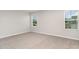 Bedroom features neutral walls, light gray carpeting, a white baseboard, and two windows with horizontal blinds at 12829 Scarlet Star Dr, Riverview, FL 33579
