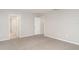Bedroom features neutral walls, light gray carpeting, white doors, baseboards, and two electrical outlets at 12829 Scarlet Star Dr, Riverview, FL 33579