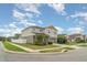 Corner lot featuring a two-story home with neutral colors, a two-car garage, landscaping, and a well-maintained lawn at 12829 Scarlet Star Dr, Riverview, FL 33579