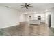 Open floor plan: Living room featuring grey wood floors and neutral walls overlooking the kitchen and dining areas at 12829 Scarlet Star Dr, Riverview, FL 33579