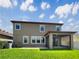 A well-maintained backyard featuring a covered patio, lush green grass, and views of the home's rear exterior at 19491 Paddock View Dr, Tampa, FL 33647