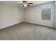 Comfortable bedroom featuring plush carpeting, a ceiling fan, and one window providing natural light at 19491 Paddock View Dr, Tampa, FL 33647