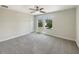 Bedroom with a ceiling fan, bright windows, and plush carpet at 19491 Paddock View Dr, Tampa, FL 33647