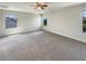 Large bedroom with multiple windows, neutral paint and carpet, offers a peaceful ambiance at 19491 Paddock View Dr, Tampa, FL 33647