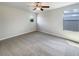 Bright bedroom with plush carpeting, ceiling fan, and two windows offering ample natural light at 19491 Paddock View Dr, Tampa, FL 33647