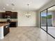 Spacious dining area featuring modern light fixture and access to outdoor area at 19491 Paddock View Dr, Tampa, FL 33647