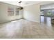 Open dining room with tile flooring, modern light fixture, and large windows with natural sunlight at 19491 Paddock View Dr, Tampa, FL 33647