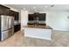 Contemporary kitchen featuring stainless steel appliances, dark cabinets and a central island at 19491 Paddock View Dr, Tampa, FL 33647
