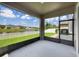 Screened lanai offering scenic views of the pond, backyard and neighborhood at 19491 Paddock View Dr, Tampa, FL 33647
