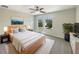 Stylishly furnished main bedroom with a ceiling fan, bright windows, and a comfortable queen-sized bed at 19491 Paddock View Dr, Tampa, FL 33647