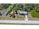 Picturesque aerial view of home with well-manicured lawn, mature trees, and tranquil pond creating a peaceful setting at 5769 E Price Blvd, North Port, FL 34288