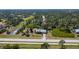 Expansive aerial view of a serene home with lush landscaping, a long driveway, and a private pond at 5769 E Price Blvd, North Port, FL 34288