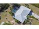 This aerial shot features a home with an inviting backyard pool, set in lush surroundings providing a sense of privacy at 5769 E Price Blvd, North Port, FL 34288