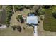 Bird's eye view features home, pool, and outbuilding amidst expansive greenery, blending comfort with nature at 5769 E Price Blvd, North Port, FL 34288