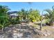 The large backyard includes a pool and plenty of lush tropical vegetation at 5769 E Price Blvd, North Port, FL 34288