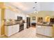 Bright kitchen with white cabinets, stainless steel appliances, and a tiled backsplash at 5769 E Price Blvd, North Port, FL 34288
