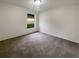 Empty bedroom featuring neutral carpet, bright natural light, and freshly painted walls at 9855 Morris Glen Way, Temple Terrace, FL 33637