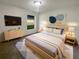 Comfortable bedroom with a large bed, modern furniture, and soft lighting at 9855 Morris Glen Way, Temple Terrace, FL 33637