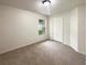 Cozy bedroom with neutral carpet, window, and a white paneled door at 9855 Morris Glen Way, Temple Terrace, FL 33637