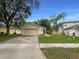 Charming single-story home with a well-maintained lawn and attached two-car garage at 9855 Morris Glen Way, Temple Terrace, FL 33637