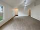 Spacious, carpeted living room offering great natural light and open space at 9855 Morris Glen Way, Temple Terrace, FL 33637