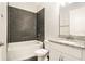 Modern bathroom features a shower and tub combination, and a white vanity with granite countertop at 9955 Patrician Dr, New Port Richey, FL 34655