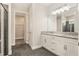 Modern bathroom featuring double sinks, granite counters, and a walk-in shower at 9955 Patrician Dr, New Port Richey, FL 34655