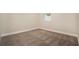 Bright bedroom features neutral walls, carpet and a window letting in natural light at 9955 Patrician Dr, New Port Richey, FL 34655